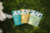 Three Momentum pet food packages on grass with a dog's paw visible.