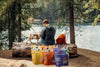Pet owner rewarding dog and cat with Momentum freeze-dried chicken breast single ingredient treats by lake with child