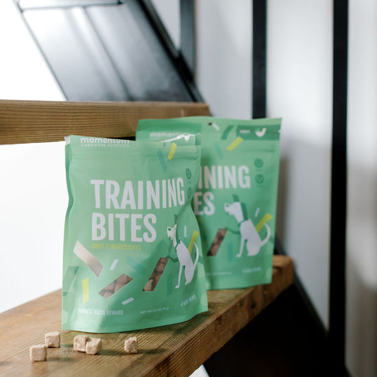 Momentum freeze-dried turkey training bites single ingredient high protein treat in green bags on stairs.